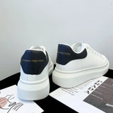 White sneakers with navy accents on a magazine background