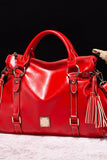 Red handbag with gold accents on a dark background