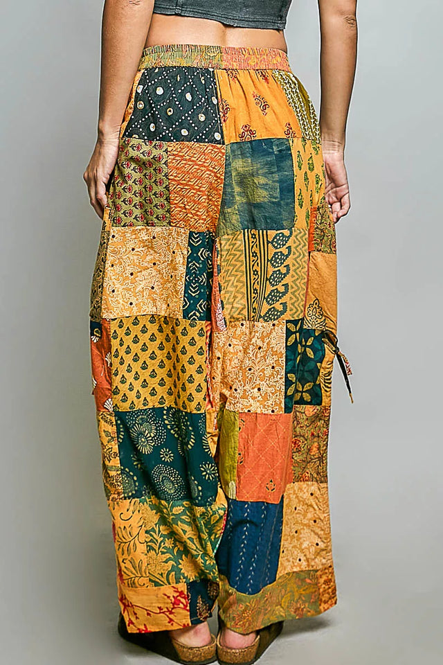 Patchwork pants with a colorful pattern on a gray background