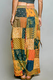 Patchwork pants with a colorful pattern on a gray background