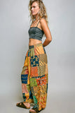 Woman wearing a colorful patchwork skirt on a plain background