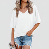 Person wearing a white oversized t-shirt and denim shorts on a white background
