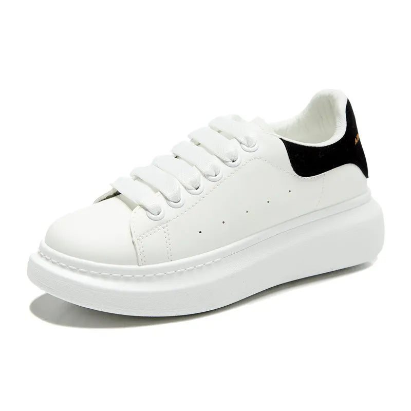 White sneaker with a black heel on a white background