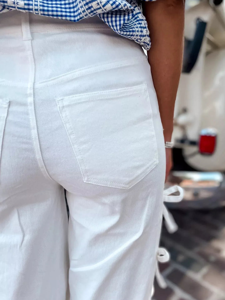 Close-up of white pants with a blurred background
