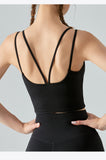 Person wearing a black sports bra and leggings on a light gray background
