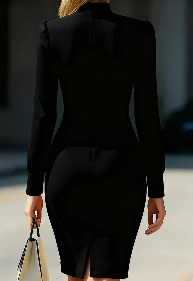 Person wearing a black suit with a blurred background