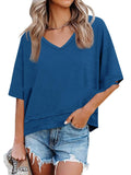 Woman wearing a blue oversized t-shirt and denim shorts on a white background