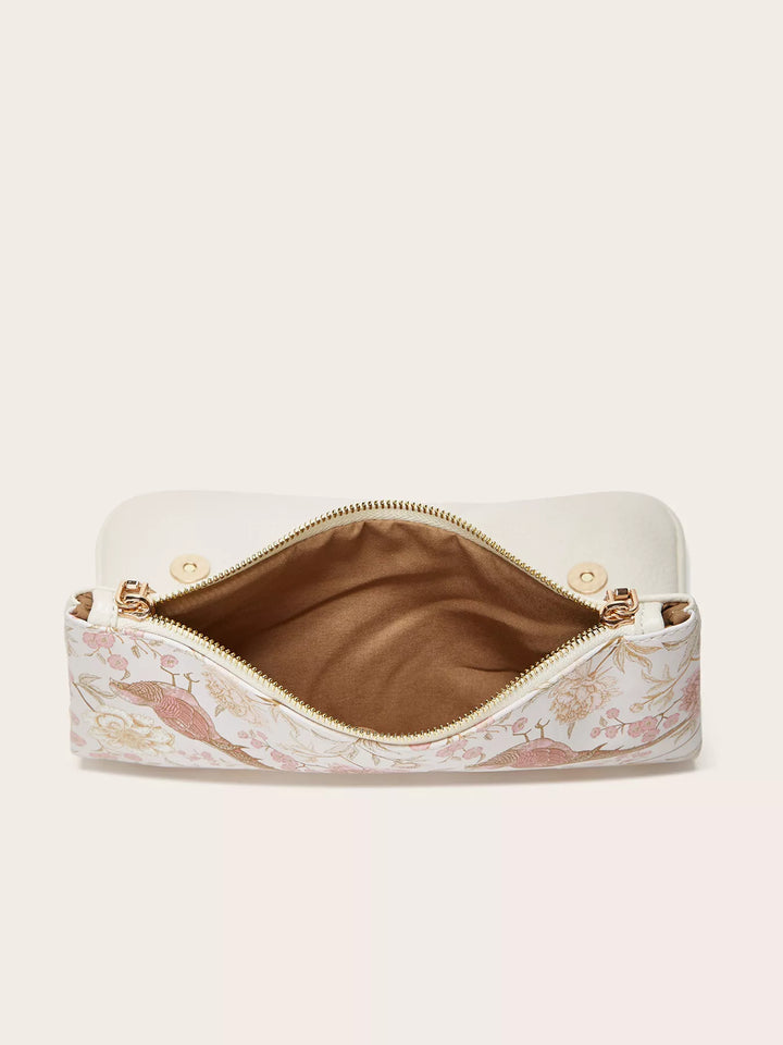 Floral-patterned makeup bag with gold zipper on a light beige background
