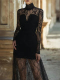 Black lace dress with long sleeves and sheer skirt against a blurred architectural background