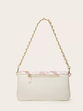 White handbag with a gold chain strap on a beige background