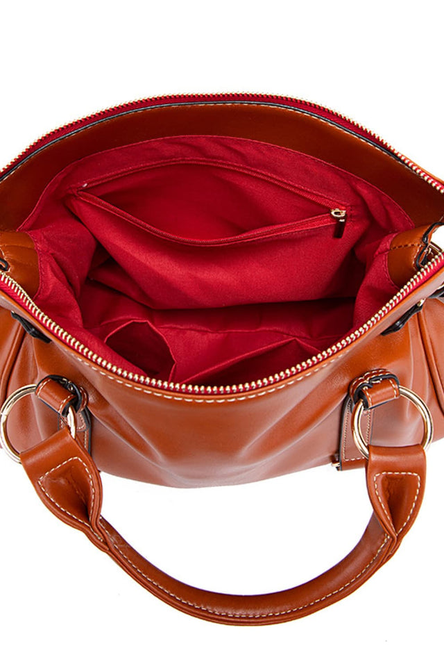 Brown handbag with red interior on a white background