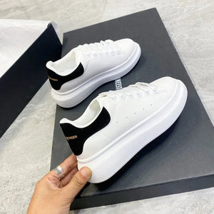 White sneakers with navy accents on a magazine background