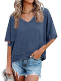 Woman wearing a blue oversized t-shirt and denim shorts on a white background