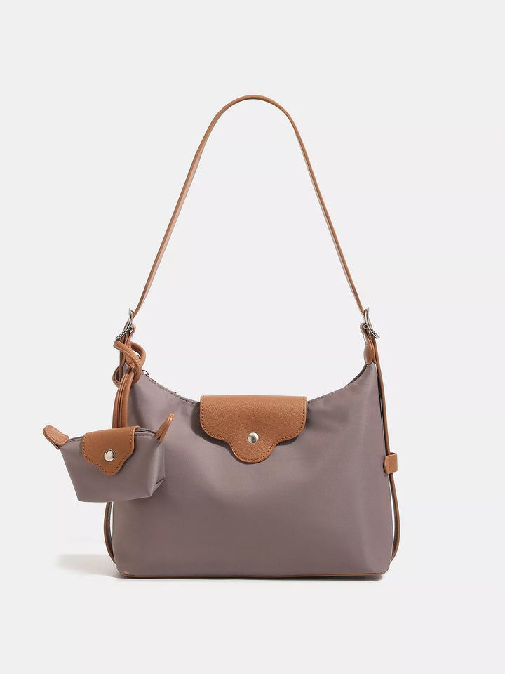 Gray handbag with brown accents on a white background