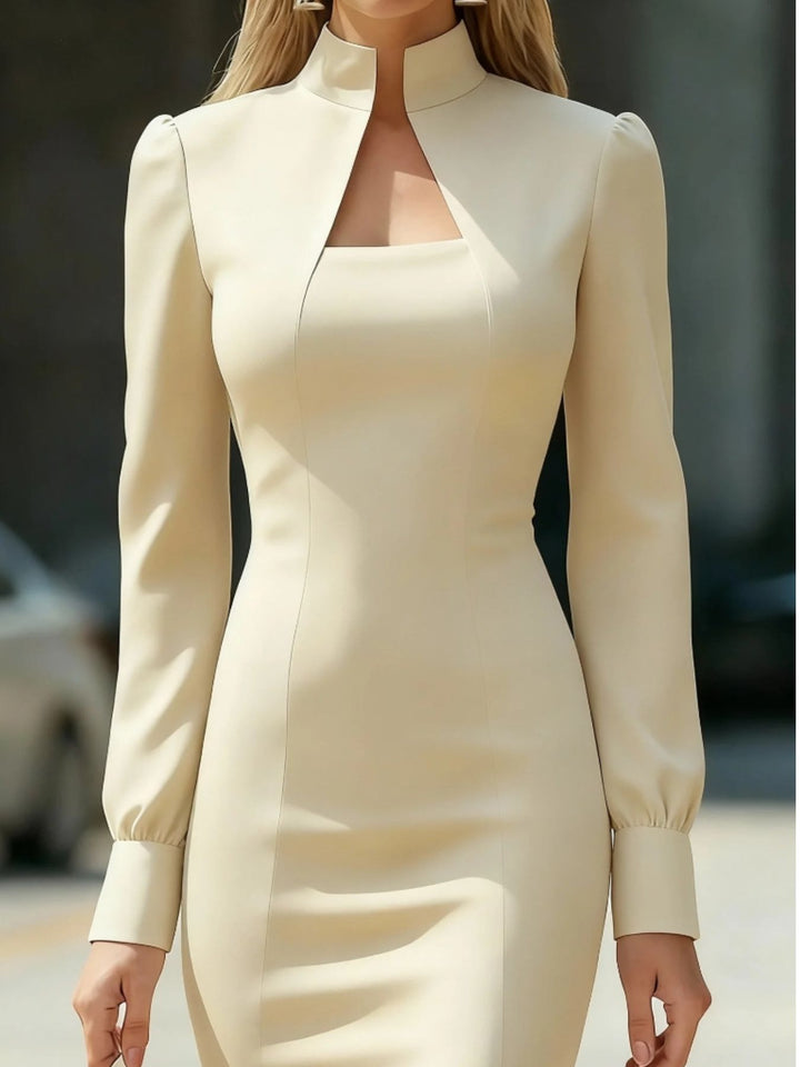 Beige long-sleeve dress worn by a person with a blurred background