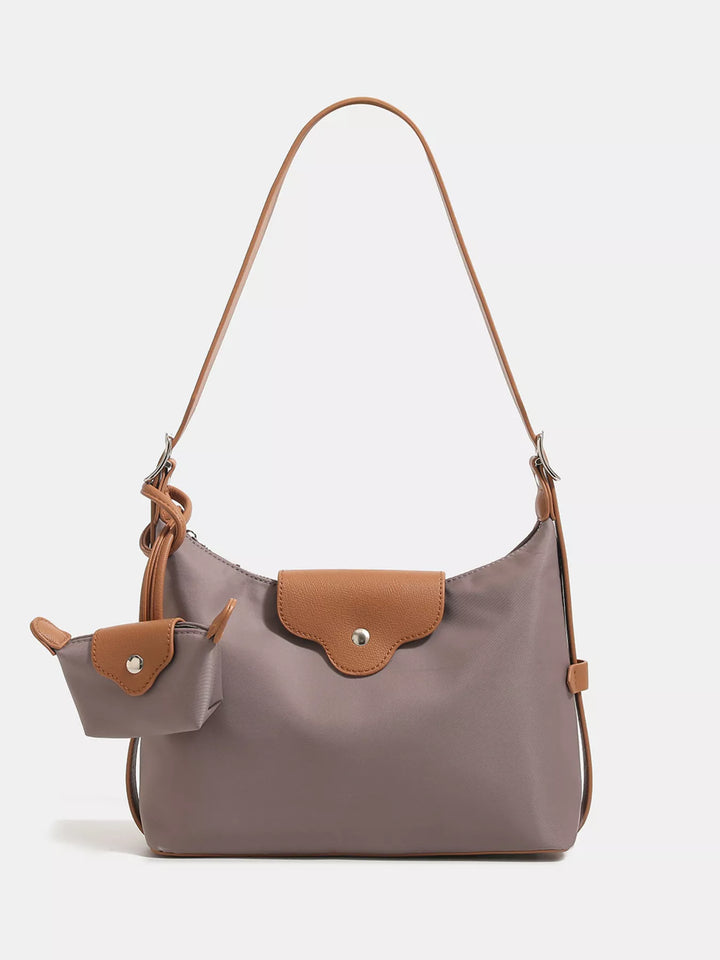 Gray handbag with brown accents on a light gray background