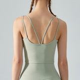Light green tank top worn by a person on a gray background