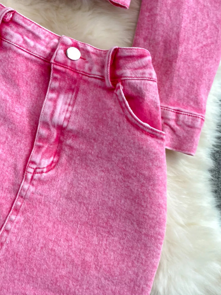 Close-up of pink denim shorts on a white fur surface
