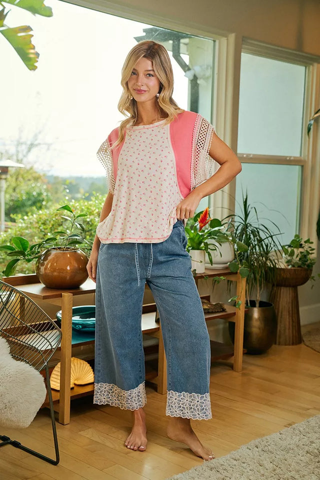 Woman standing in a room with plants and a window view