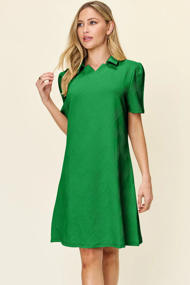 Woman wearing a green dress against a beige background