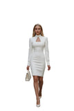 Woman wearing a white dress with long sleeves in an urban setting
