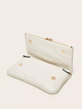 White clutch bag with gold zipper and buttons on a light beige background