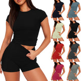Woman wearing a black outfit with multiple color options displayed around her.