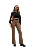 Beige wide-leg pants worn by a person in a minimal indoor setting.