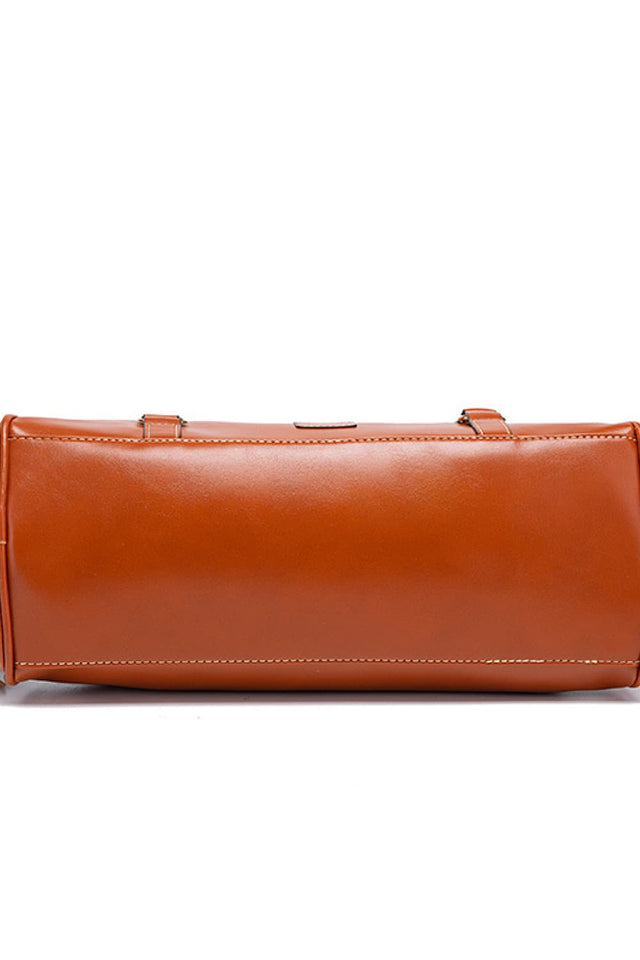 Brown leather clutch bag on a white background