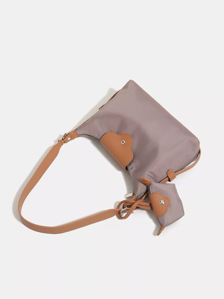 Handbag with a beige strap on a white background