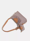 Handbag with a beige strap on a white background
