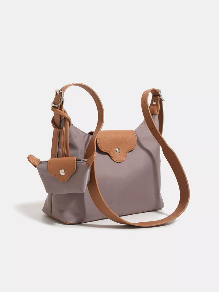 Gray handbag with brown accents on a light gray background