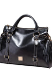 Black leather handbag with gold accents on a dark background