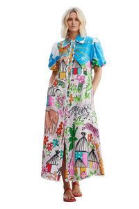Woman wearing a colorful dress with abstract patterns on a neutral background