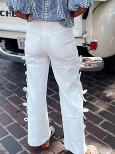 Close-up of white pants with a blurred background