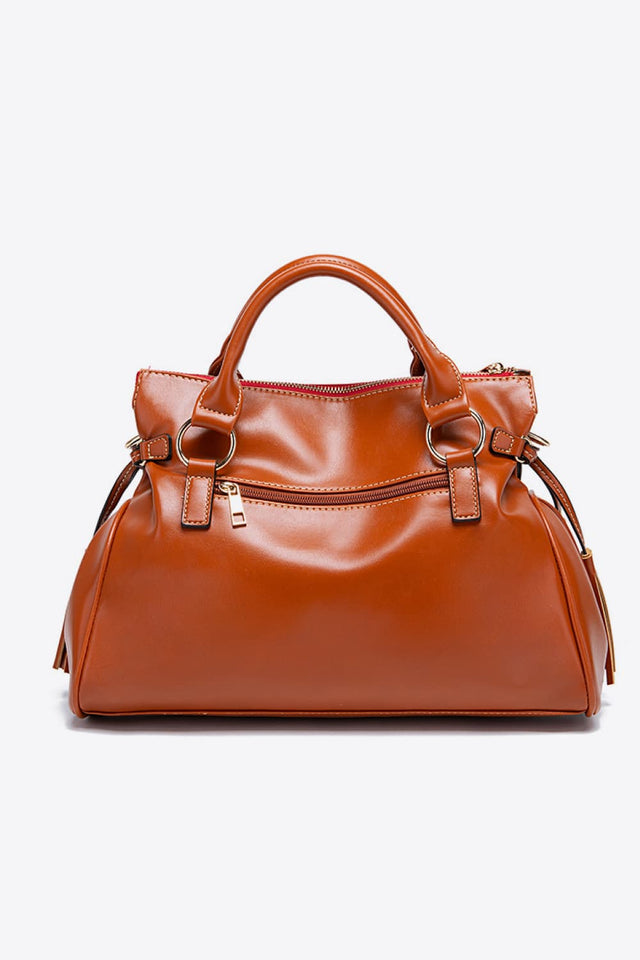 Brown leather handbag on a white background