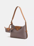 Gray handbag with brown accents on a white background