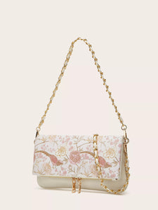 White handbag with a gold chain strap on a beige background