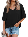 Person wearing a black oversized t-shirt and denim shorts on a white background