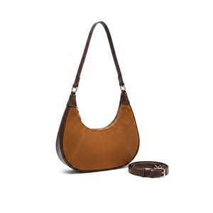 Person wearing a dark gray blazer and holding a brown handbag.