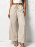 Beige wide-leg pants worn by a person on a white background