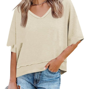 Beige oversized t-shirt worn by a person on a white background