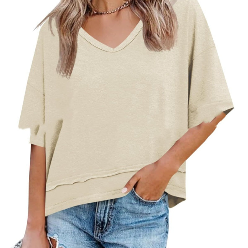 Beige oversized t-shirt worn by a person on a white background