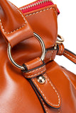 Close-up of a brown leather handbag with gold hardware on a white background