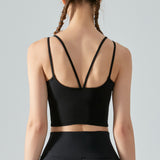 Person wearing a black sports bra and leggings on a gray background